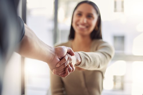 Woman shaking another person's hand